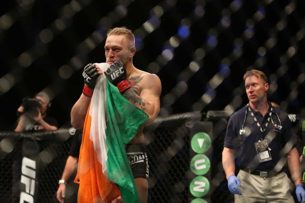 Ireland’s Conor McGregor hold the Irish flag