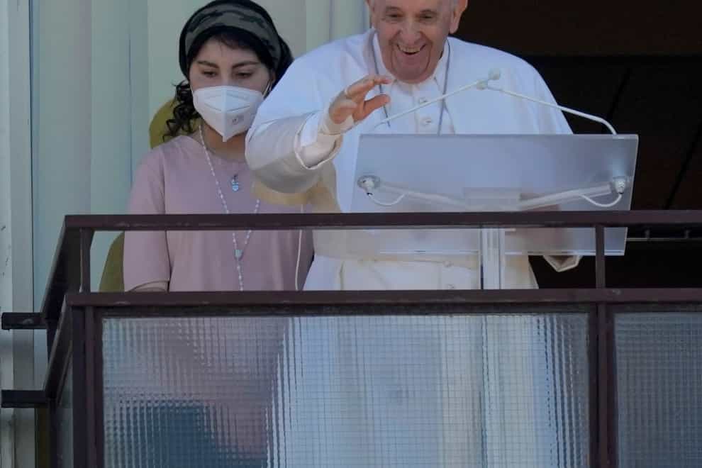 Pope Francis appears with a young patient on a balcony of the Agostino Gemelli Polyclinic in Rome