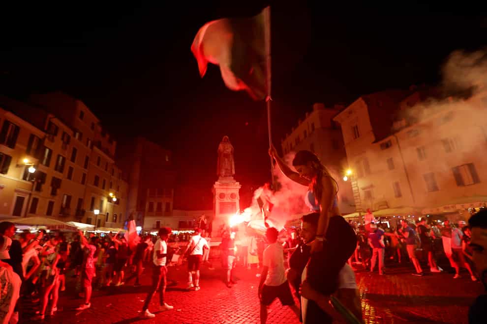 Italy’s fans celebrate in Rome (Riccardo De Luca/AP)
