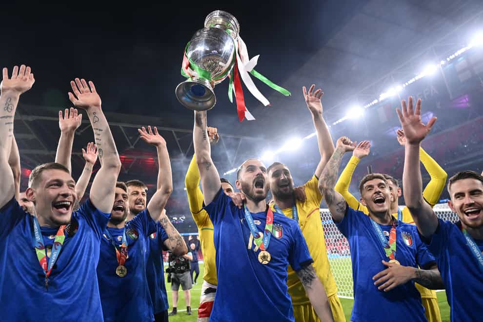 Italy’s Leonardo Bonucci throws the trophy in the air after winning Euro 2020