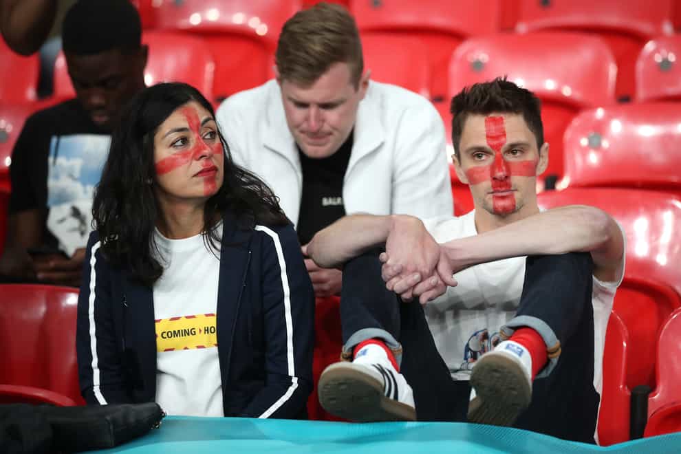 England fans sit dejected in the stands following defeat in the penalty shoot-out after the UEFA Euro 2020 Final