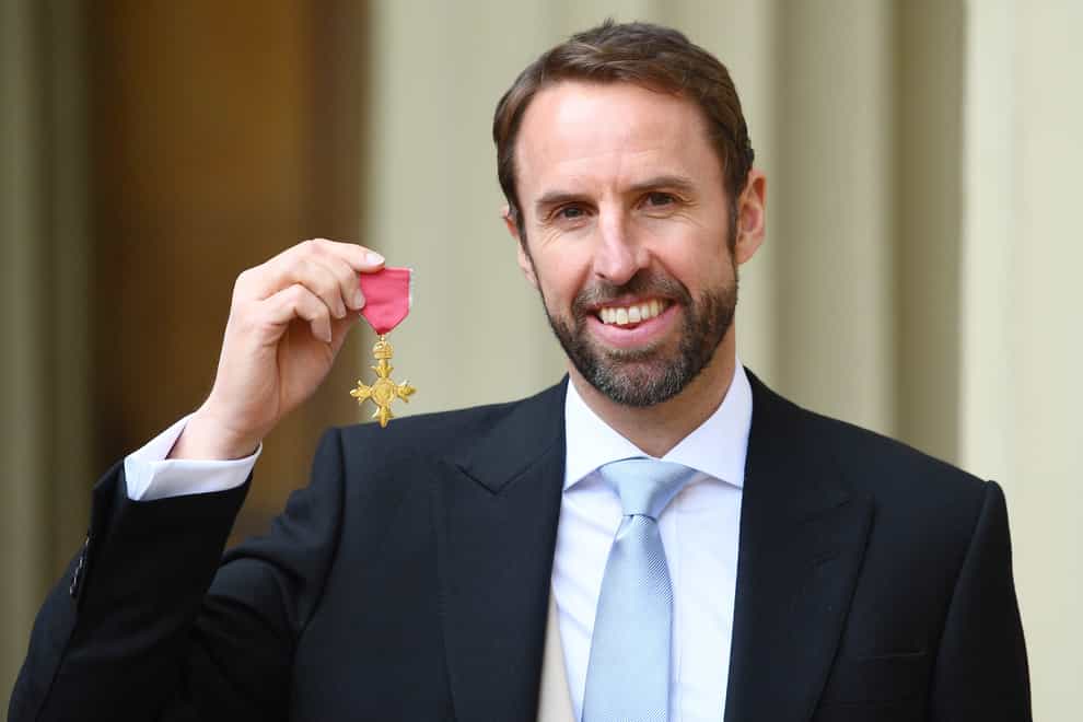 Gareth Southgate with the OBE medal that he received in 2019