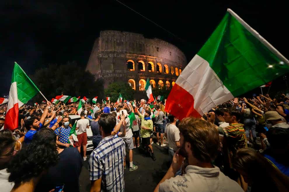 <p>Italy’s fans celebrate in front of the Colosseum in Rome (Alessandra Tarantino/AP)</p>