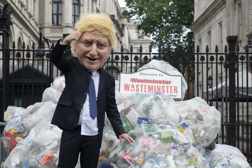 Greenpeace activists dump plastic waste by Downing Street