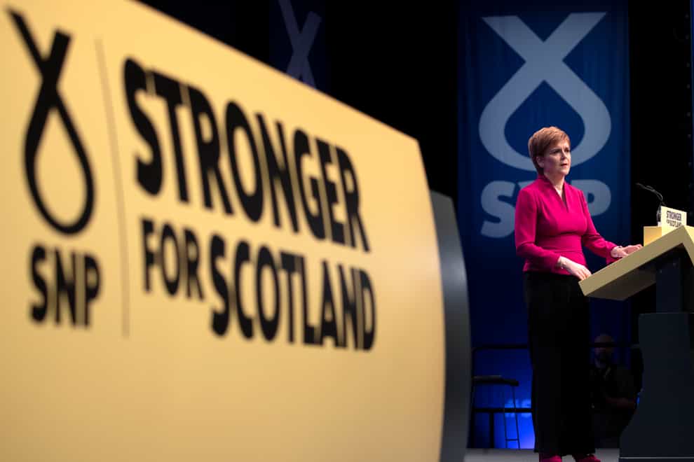 An SNP sign and Nicola Sturgeon