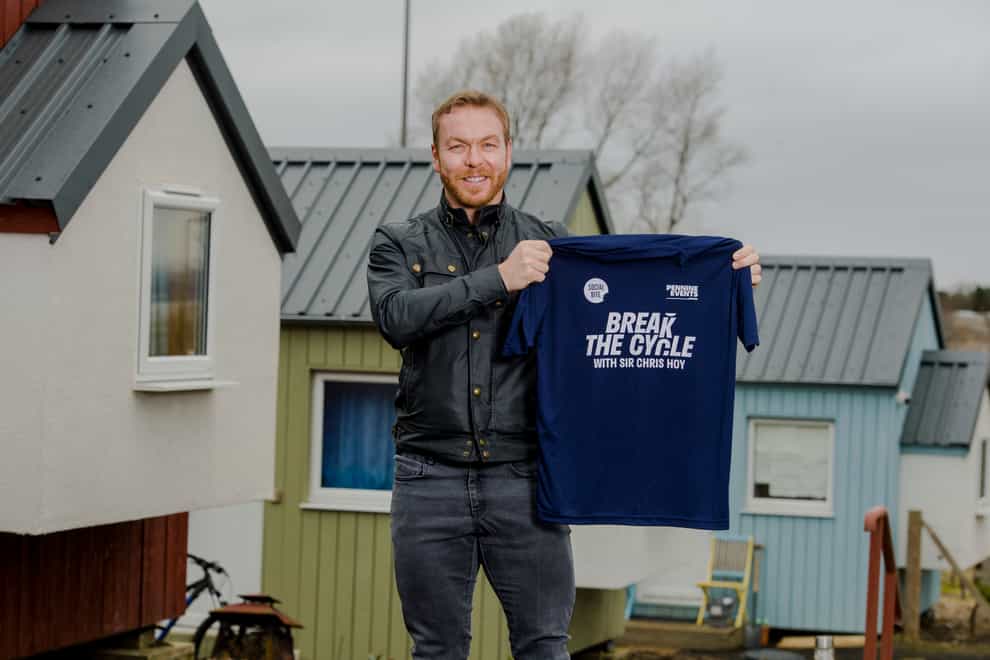 Sir Chris Hoy holds up a Break the Cycle T-shirt