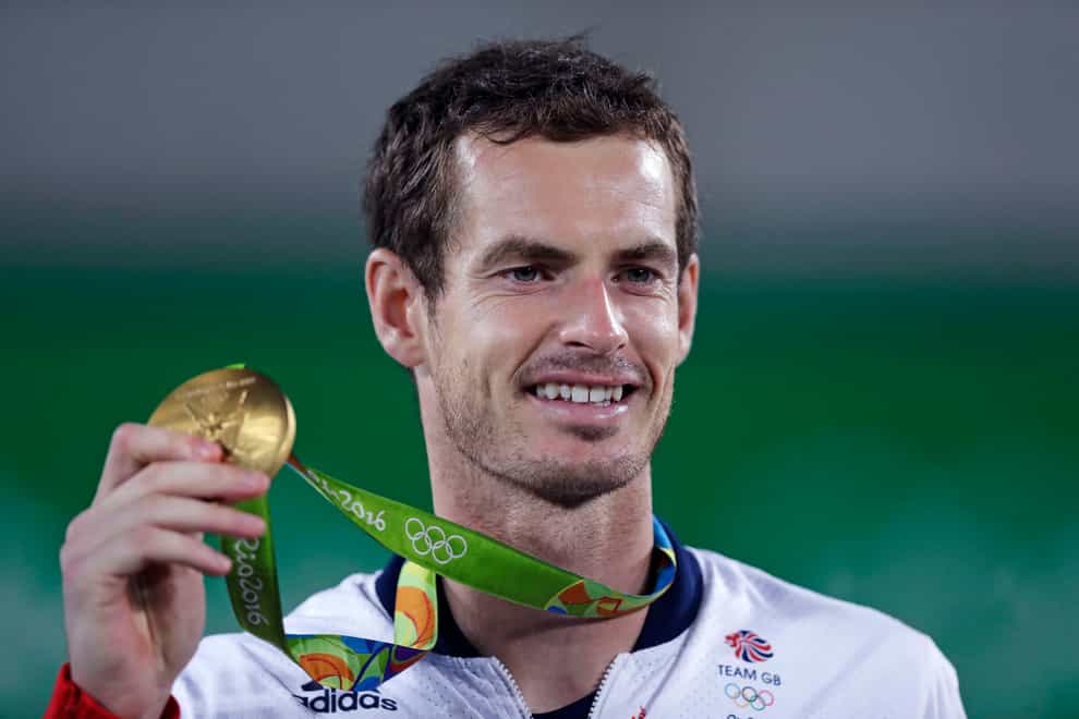 Andy Murray smiles as he holds up his gold medal in 2016