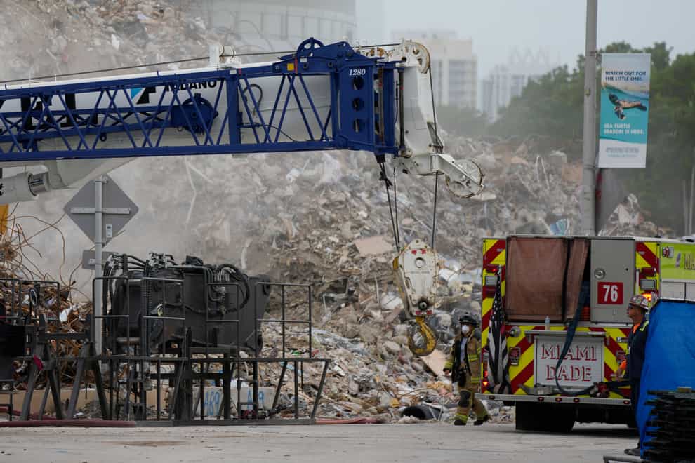 Crews work in the rubble of the demolished section of the Champlain Towers South building