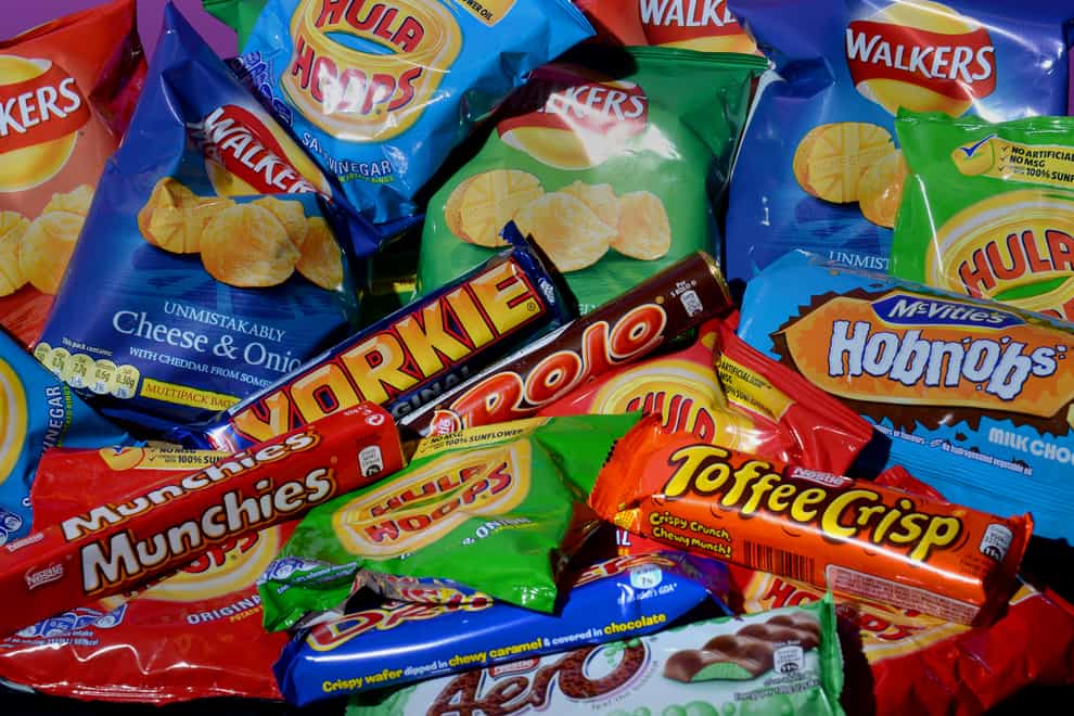 A collection of biscuits, crisps, chocolate bars and carbonated drinks
