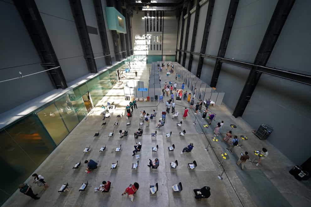People waiting for their vaccinations at an NHS pop-up vaccination centre at the Tate Modern art gallery in London (Kirsty O'Connor/PA)