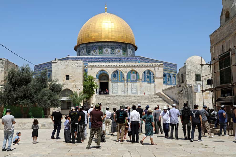 Israeli Jewish men stand at the steps leading to the Dome of the Rock Mosque in the Al Aqsa Mosque compound, during the annual mourning ritual of Tisha B’Av (the ninth of Av) (Mahmoud Illean/AP)