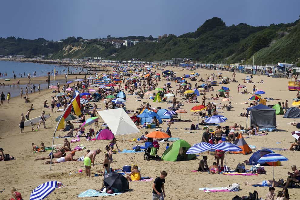 People enjoy the weather on Bournemouth beach