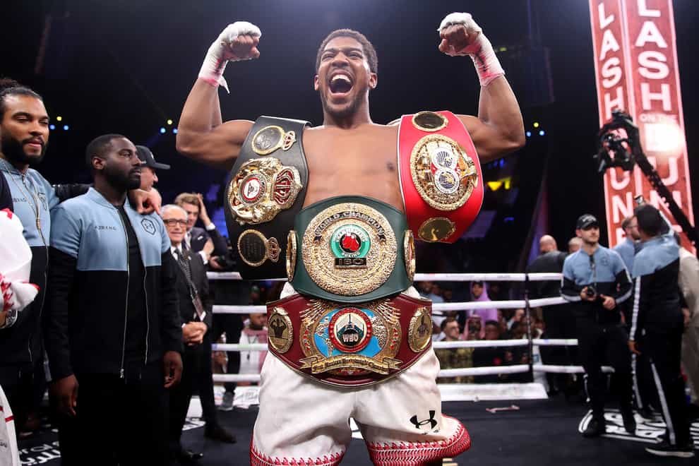 Anthony Joshua shows off his belts