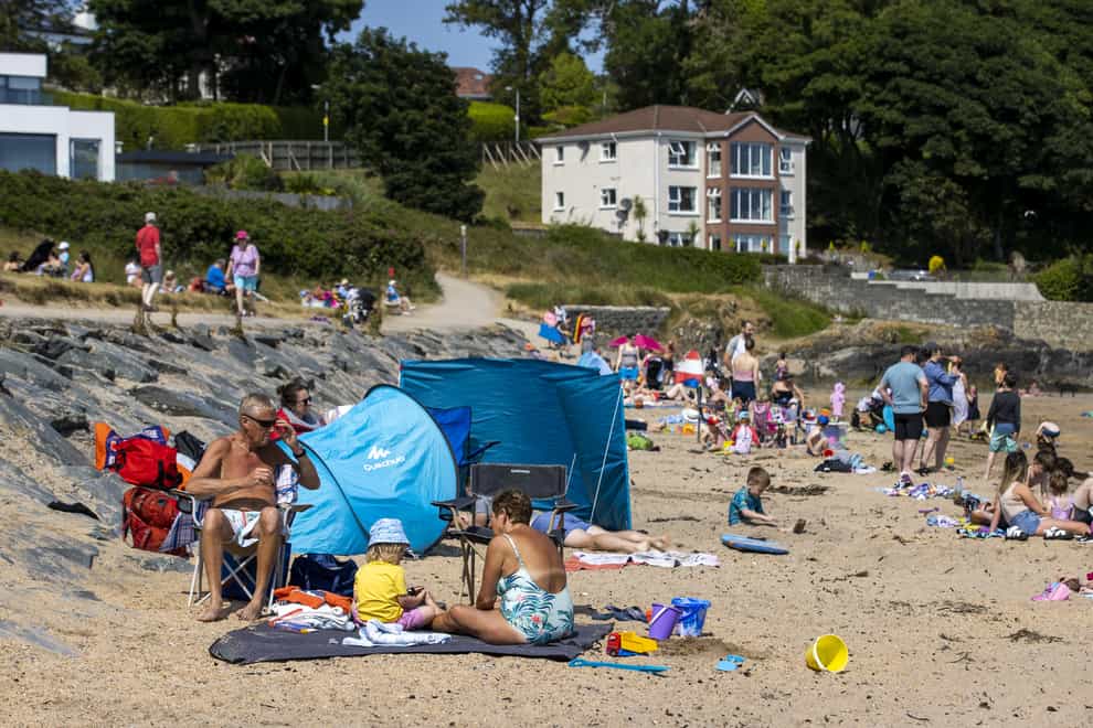 People enjoying the sun at Helen's Bay beach in County Down, Northern Ireland