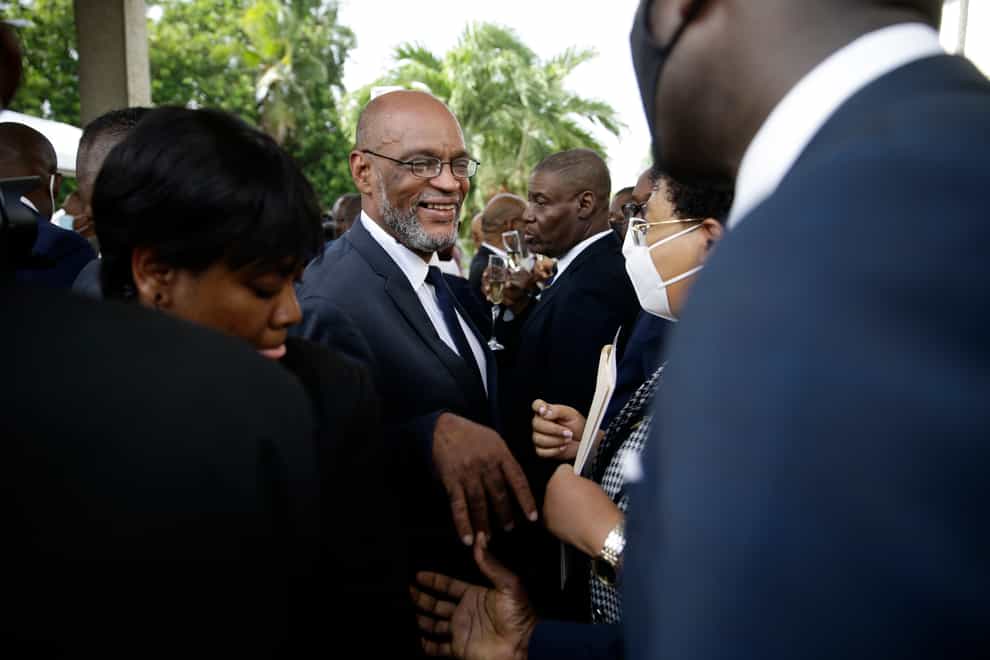 New Haiti prime minister Ariel Henry, centre, talks to members of his cabinet