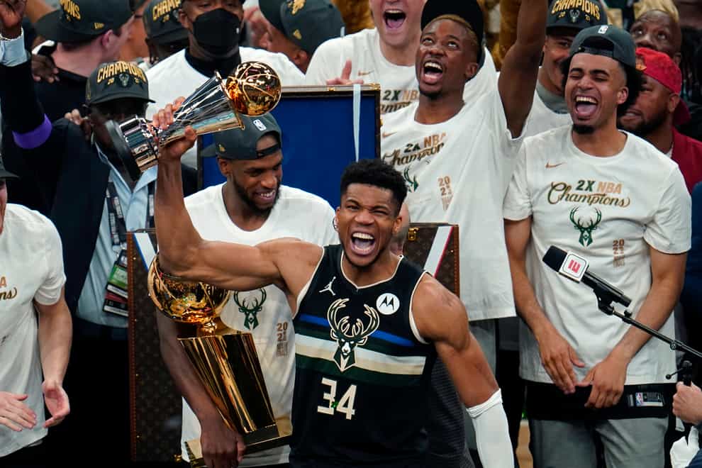Milwaukee Bucks forward Giannis Antetokounmpo (34) holds the finals MVP trophy after the Bucks defeated the Phoenix Suns in Game 6 of basketball’s NBA Finals