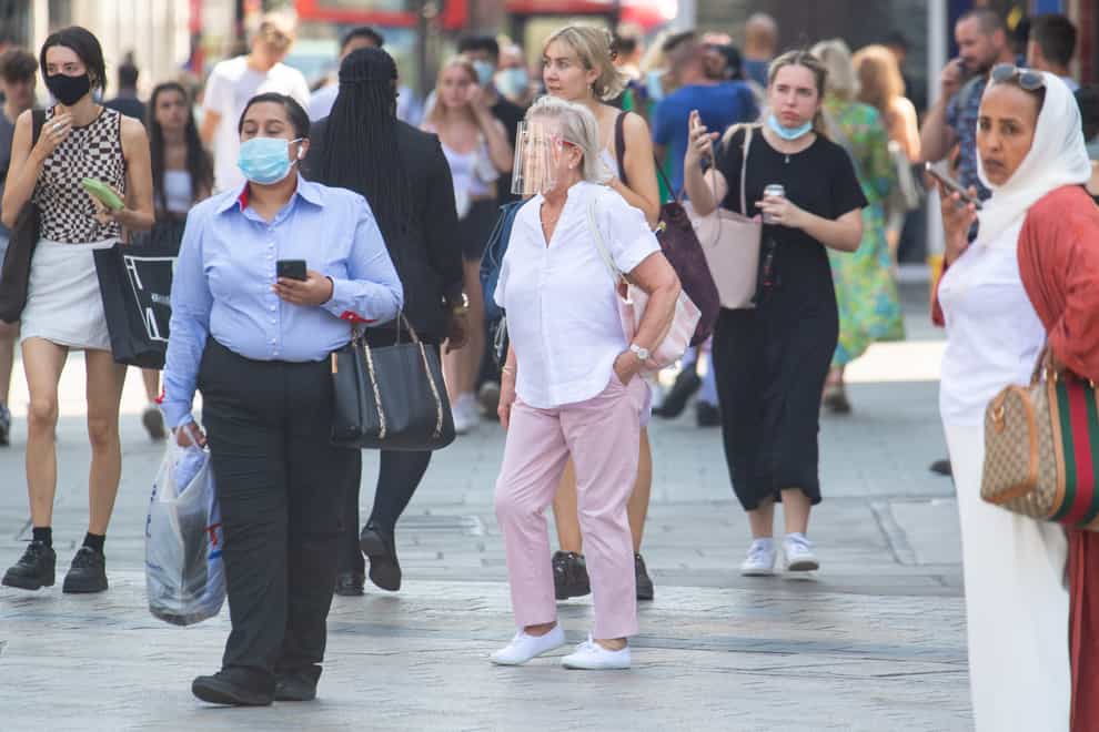 People wearing face masks in central London (Dominic Lipinski/PA)