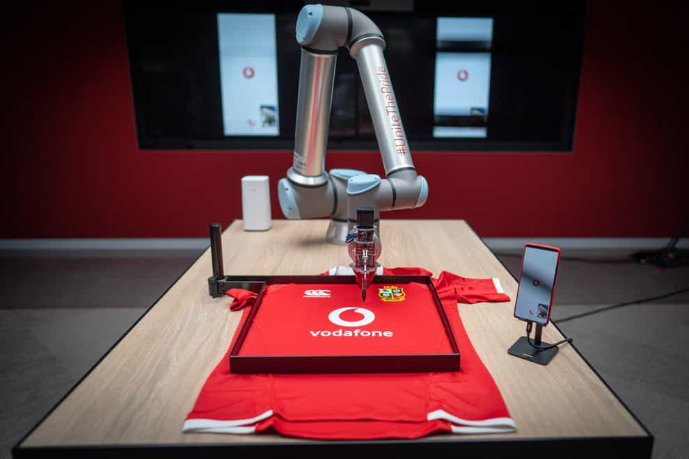 British & Irish Lions located in South Africa sign shirts of fans back in London, using 5G robotic arm