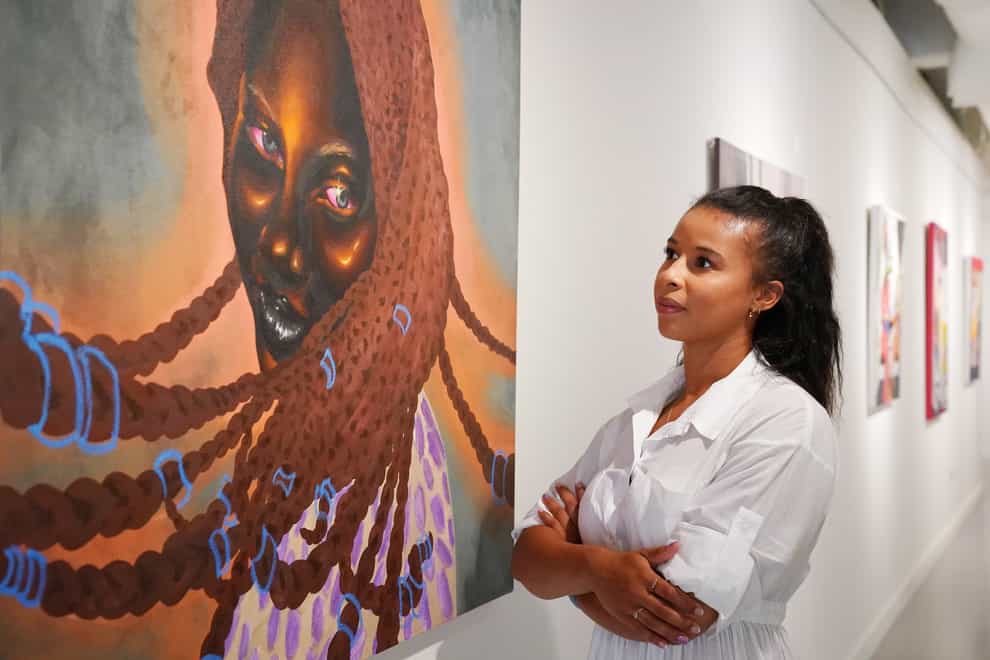 A Hofa Gallery employee looks at ‘Serena’ by Chinaza Agbor (Jonathan Brady/PA)