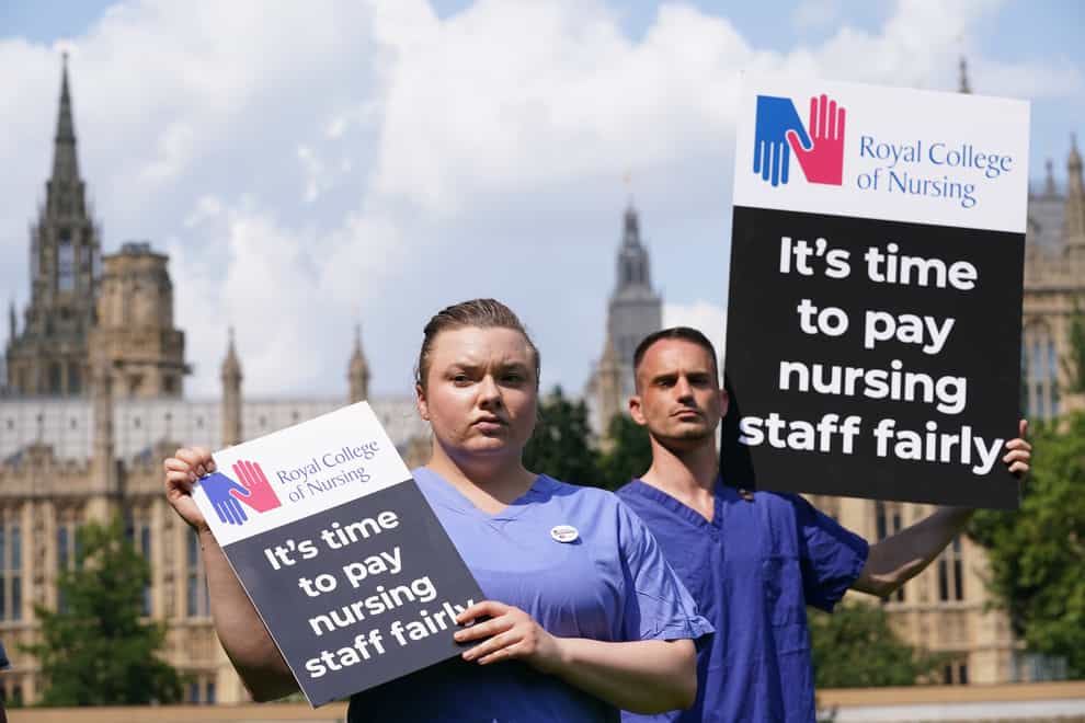 Nurses with placards outside the Royal College of Nursing in Victoria Tower Gardens, London (PA)