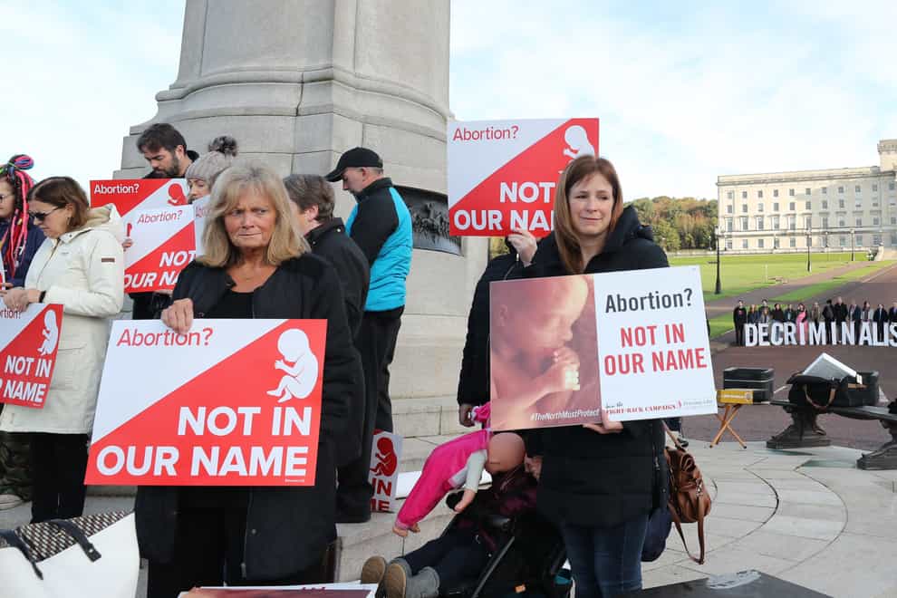 Anti-abortion and pro-choice activists take part in separate protests at Stormont (Niall Carson/PA)