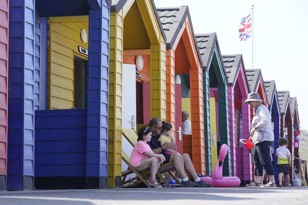 People by the beach at Saltburn-by-the-Sea in North Yorkshire. A heatwave which has baked the UK over the last few days is expected to end with thunderstorms across much of England and Wales this weekend, forecasters have warned. Picture date: Thursday July 22, 2021.