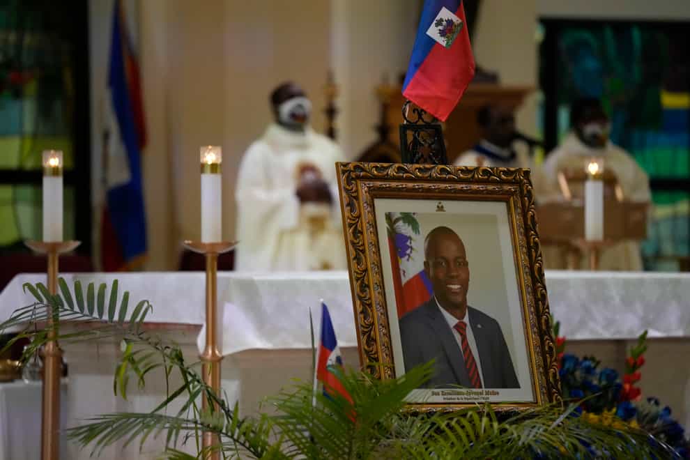 A photograph of Haiti’s assassinated President Jovenel Moise is displayed during a memorial service at Notre Dame d’Haiti Catholic Church in the Little Haiti neighbourhood of Miami (Rebecca Blackwell/AP)