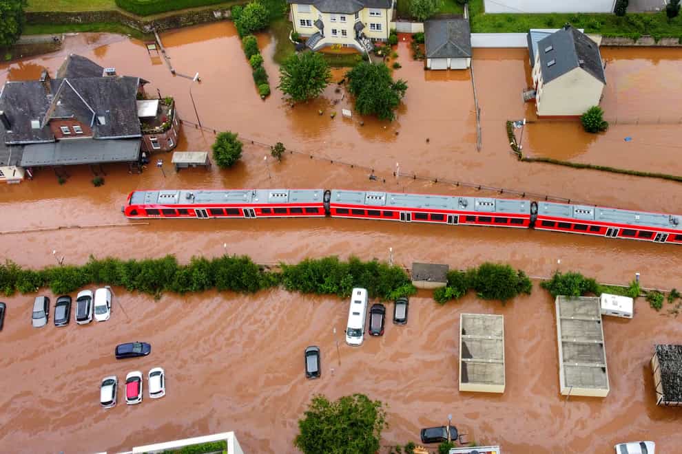 A regional train sits in flood waters at the local station in Kordel, Germany (Sebastian Schmitt/dpa via AP)