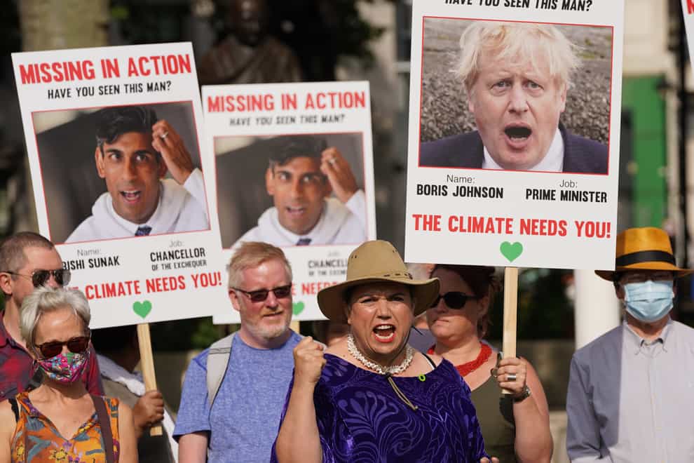 Campaigners hold placards of Prime Minister Boris Johnson and Chancellor Rishi Sunak during a demonstration organised by the Climate Coalition in London’s Parliament Square to mark 100 days to go until the Cop26 climate summit in Glasgow (Stefan Rousseau/PA)