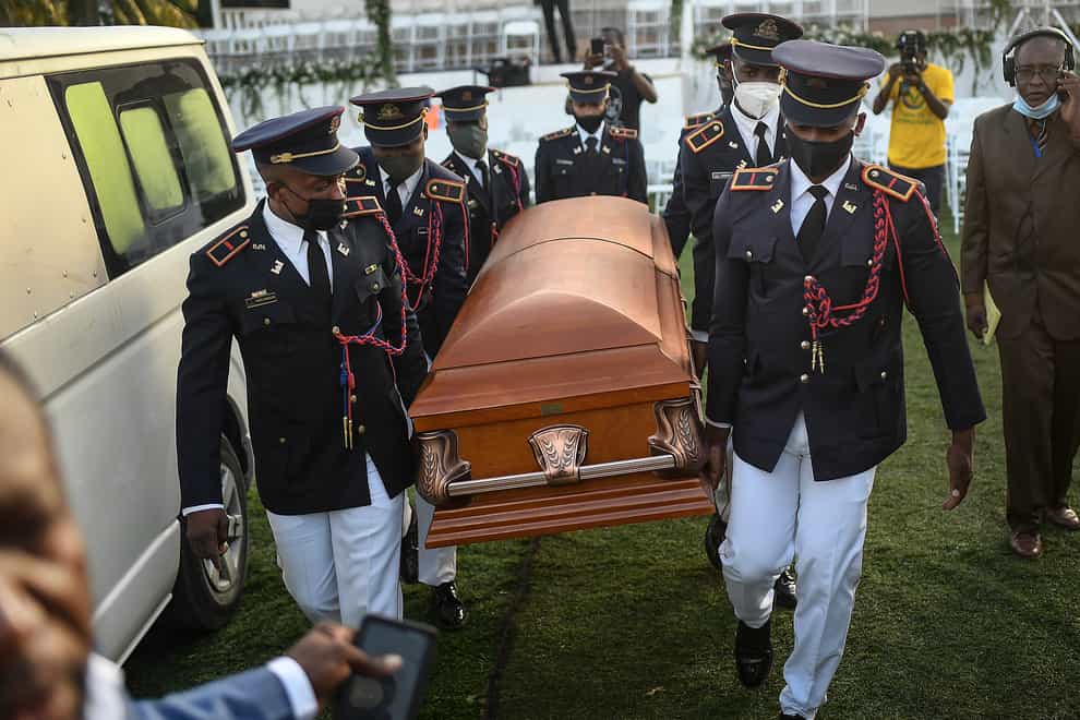 Police carry the coffin of murdered Haitian president Jovenel Moise (Matias Delacroix/AP)
