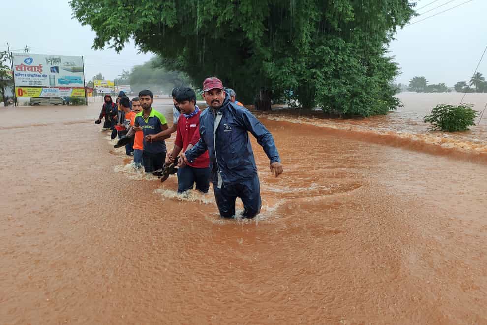 National Disaster Response Force personnel rescue people stranded in floodwaters in Kolhapur, in the western Indian state of Maharashtra, Friday, July 23, 2021. Landslides triggered by heavy monsoon rains hit parts of western India, killing at least 32 people and leading to the overnight rescue of more than 1,000 other people trapped by floodwaters, officials said Friday. (AP Photo)