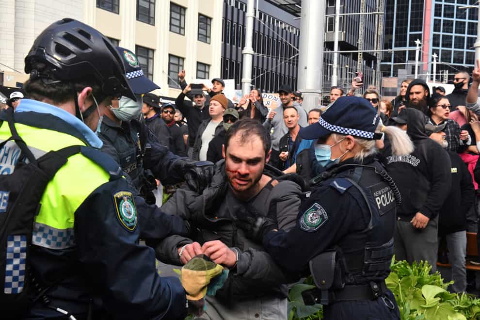 A protester (centre) is arrested by police at a demonstration at Sydney Town Hall (Mick Tsikas/AAP Image via AP/PA)