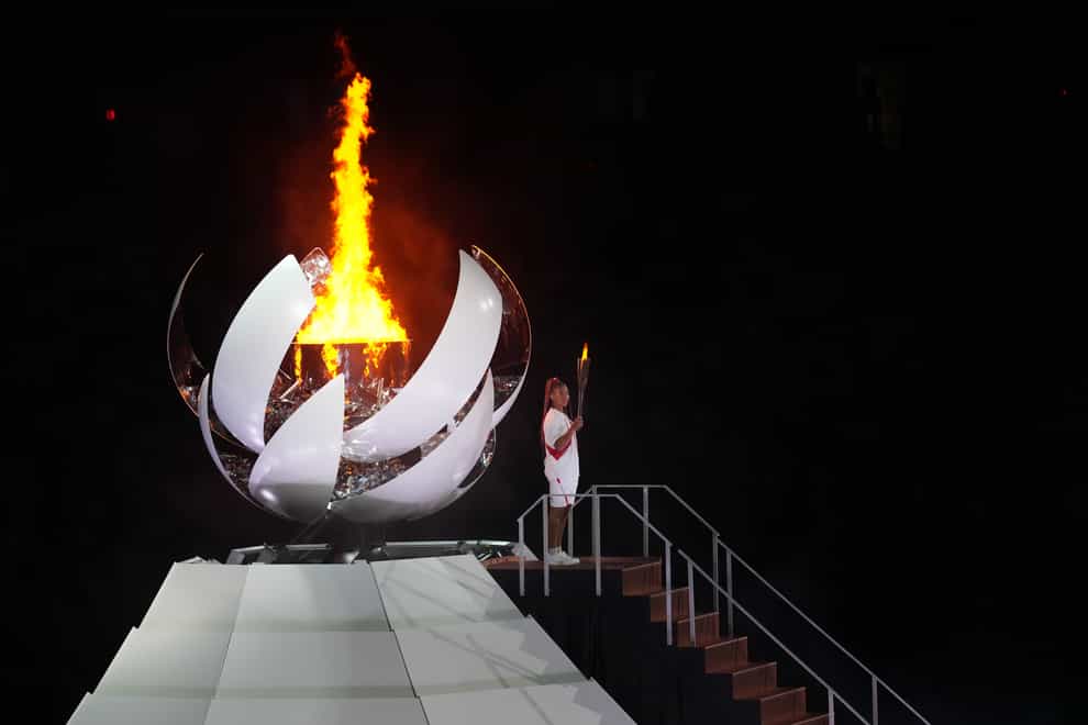 Naomi Osaka lights the Olympic flame during the opening ceremony of the Tokyo 2020 Olympic Games (Martin Rickett/PA Images)