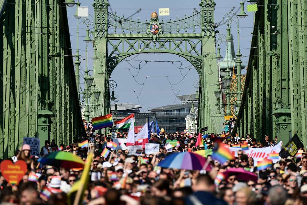 People march across the Szabadsag, or Freedom Bridge over the River Danube (AP)