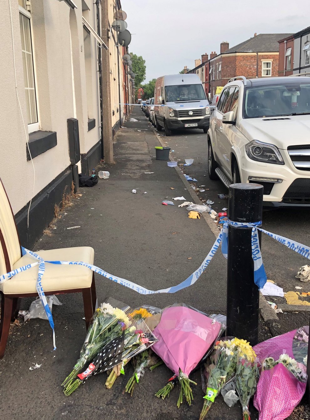 Flowers left at East Street in Bury, Greater Manchester, where a 31-year-old woman died from severe burns (Kim Pilling, PA)