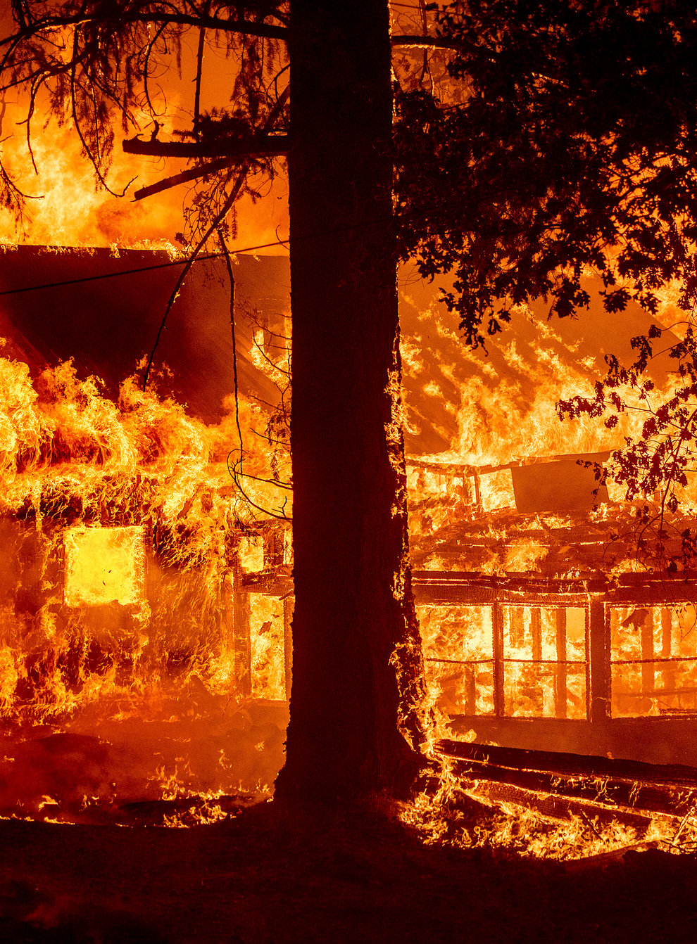 Flames from the Dixie fire consume a home in the Indian Falls community of Plumas County, California (Noah Berger/AP)