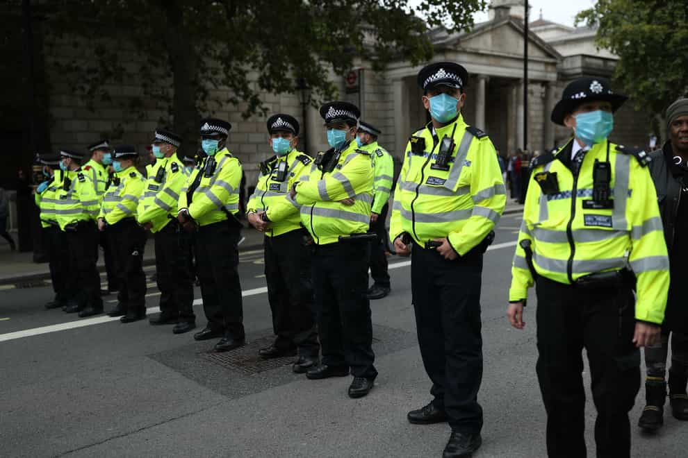 Police officers wearing face masks (PA)