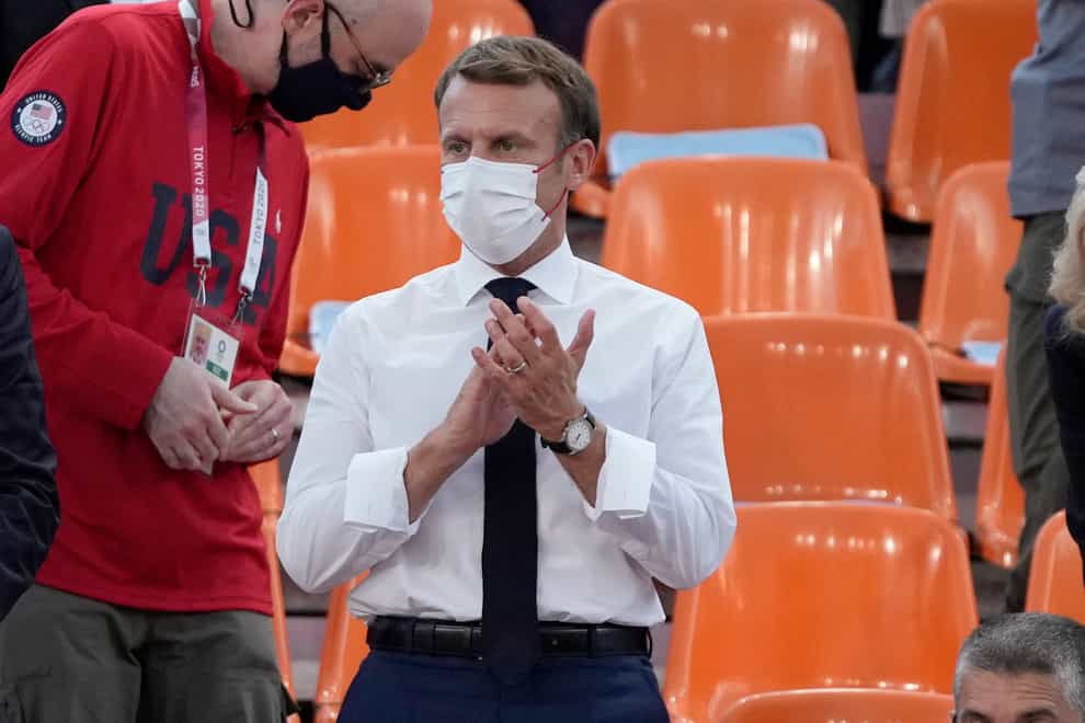 French President Emmanuel Macron applauds as he watches the Olympic basketball game between France and the US in Tokyo (Jeff Roberson/AP)