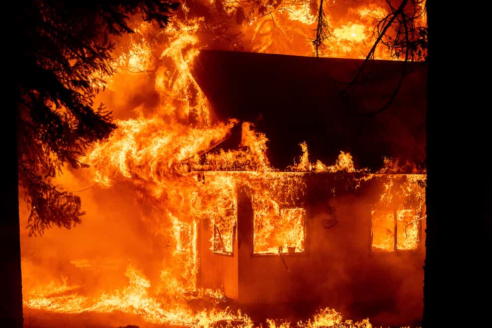 Flames consume a home as the Dixie Fire tears through the Indian Falls community in Plumas County (Noah Berger/AP)