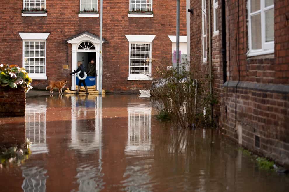 Residents on a flooded street in Bewdley, Worcestershire, after the River Severn burst its banks (PA)
