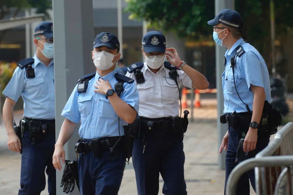 Police officers stand guard as they wait for Tong Ying-kit’s arrival at a court in Hong Kong (Vincent Yu/AP)