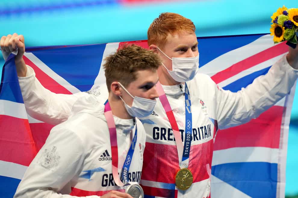 Great Britain’s Tom Dean (right) with his gold medal celebrates after winning the Men’s 200m Freestyle alongside second placed silver medalist Great Britain’s Duncan Scott (Joe Giddens/PA)