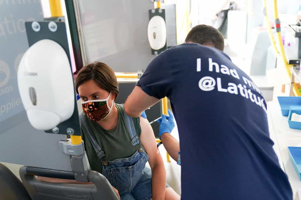 Felicity Perry receives her second dose of a Covid-19 vaccine on board a vaccination bus at the Latitude festival in Henham Park, Southwold, Suffolk (Jacob King/PA)