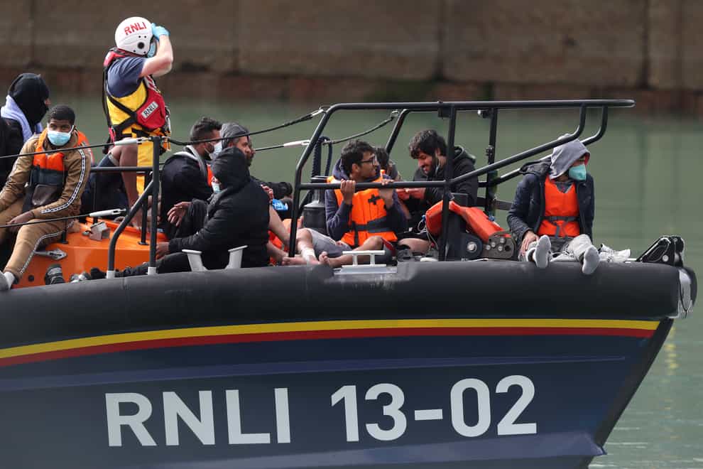 A group of people thought to be migrants are brought into Dover, Kent, by the RNLI (PA)