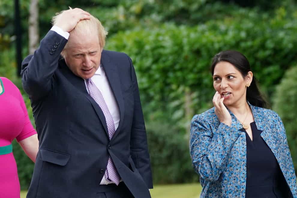 Prime Minister Boris Johnson and Home Secretary Priti Patel during a visit to Surrey Police headquarters to coincide with the publication of the government’s Beating Crime Plan (PA)