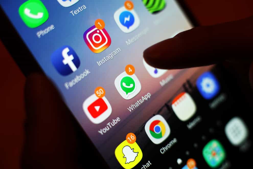 The icons of social media apps, including Facebook, Instagram, YouTube and WhatsApp, are displayed on a mobile phone screen, in London.