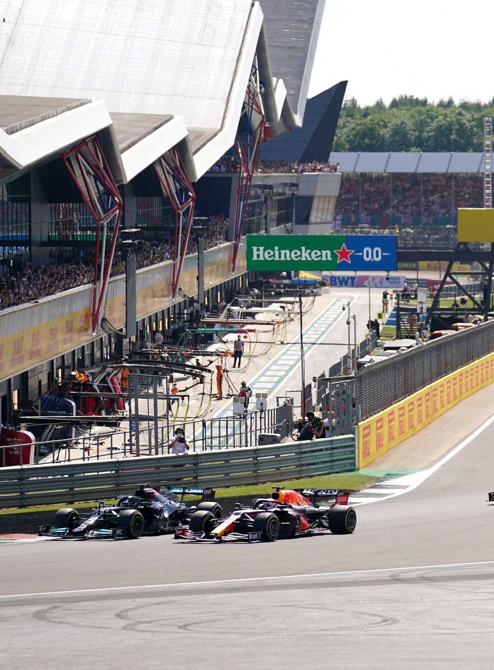 Mercedes’ Lewis Hamilton and Red Bull Racing’s Max Verstappen lead the race at the start of the race during the British Grand Prix at Silverstone, Towcester. Picture Date: Sunday July 18, 2021.