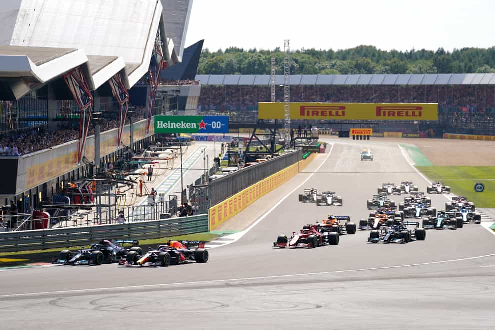 Mercedes’ Lewis Hamilton and Red Bull Racing’s Max Verstappen lead the race at the start of the race during the British Grand Prix at Silverstone, Towcester. Picture Date: Sunday July 18, 2021.