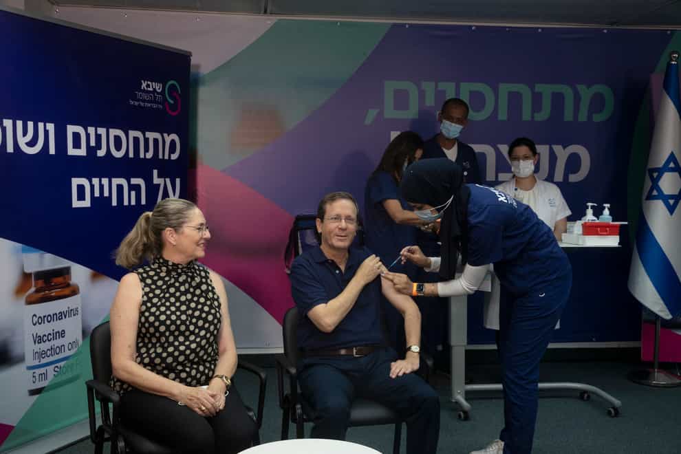 Israeli president Isaac Herzog receives his booster jab (Maya Alleruzzo/AP)