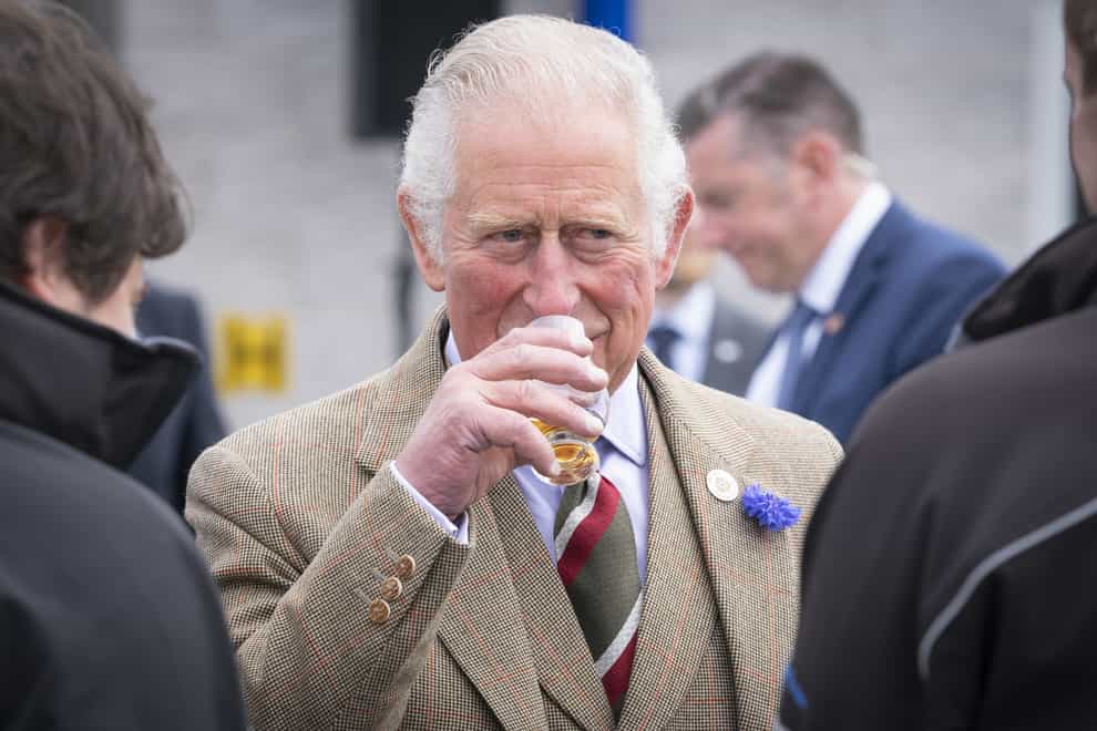 The Prince of Wales has a dram of whisky before officially opening the Lerwick Harbour and Scalloway fish markets (Jane Barlow/PA)